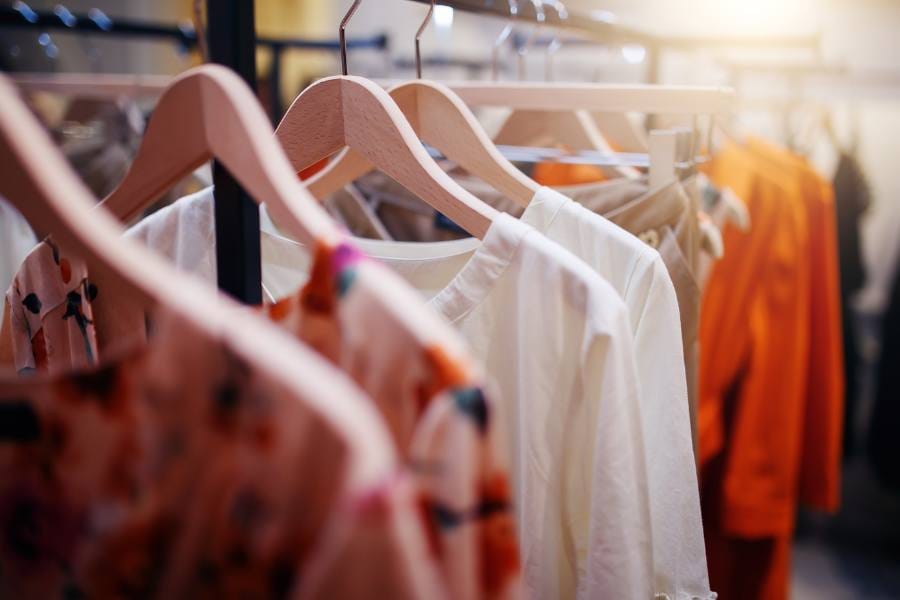 Clothes hanging on a rack at a boutique